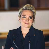 Smiling woman with short blonde hair