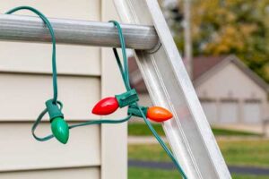 christmas lights wrapped around ladder rung