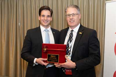 two smiling men holding gavel